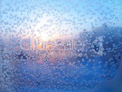 Ice pattern and sunlight on winter glass