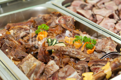 Lamb meat in a heated tray
