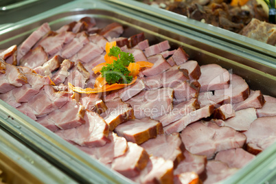 Cooked ham served in a heated tray