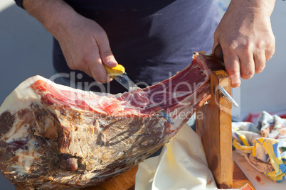 Man slicing Dalmatian prosciutto