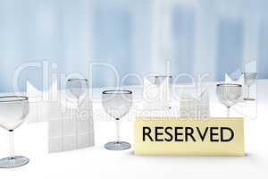 Table with glasses and sign "Reserved"