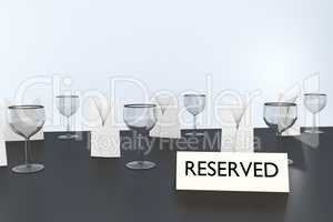 Table with glasses and sign "Reserved"