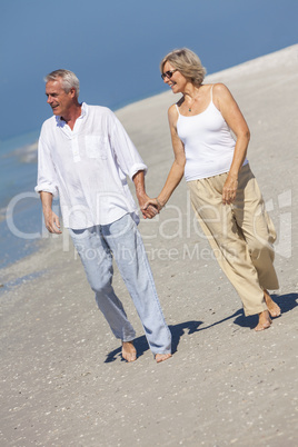 Happy Senior Couple Walking Holding Hands Tropical Beach