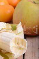 Mandarin Apples and Bananas on wooden plate