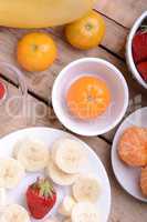 Fresh colorful fruits composition mandarin, strawberry, peach, bananas and orange