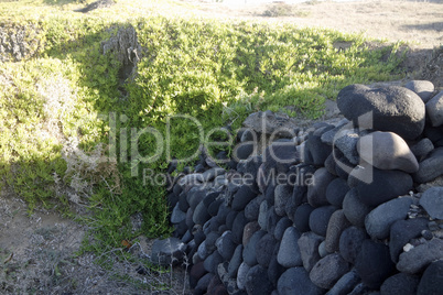 natural black lava beach koulombos on santorini island