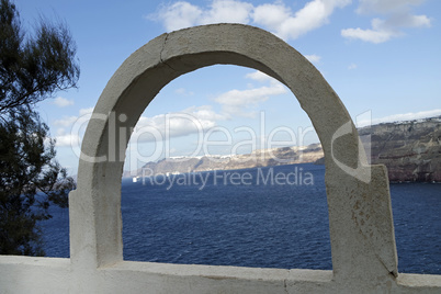 view through archway to aegean sea of santorini island