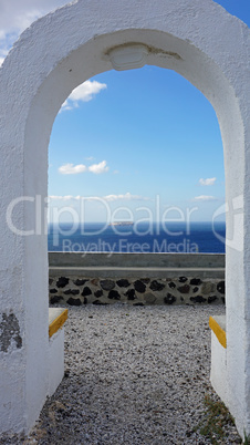 view through archway to aegean sea of santorini island