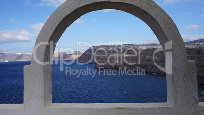 view through archway to aegean sea of santorini island