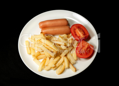 sausage served with french fries and tomatoes