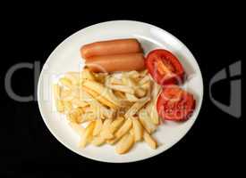 sausage served with french fries and tomatoes