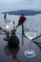 a vine glass and a rose on greece island