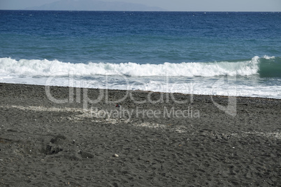 volcanic beach in kamari on santorini siland