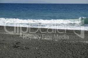 volcanic beach in kamari on santorini siland