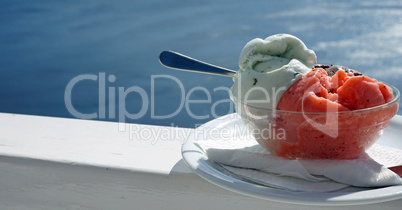 fresh ice cream in front of blue sea at santorini island