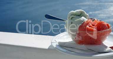 fresh ice cream in front of blue sea at santorini island