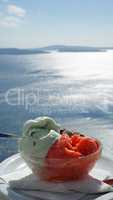 fresh ice cream in front of blue sea at santorini island