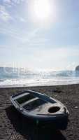 boat on volcanic beach on santorini siland