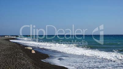 volcanic beach in kamari on santorini siland