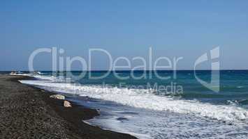 volcanic beach in kamari on santorini siland