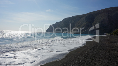 volcanic beach in kamari on santorini siland