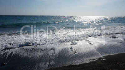 volcanic beach in kamari on santorini siland