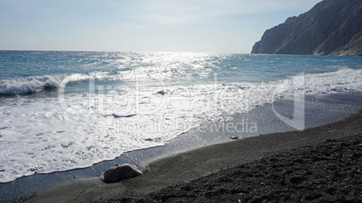 volcanic beach in kamari on santorini siland