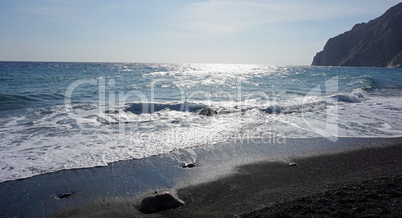 volcanic beach in kamari on santorini siland