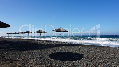 natural black lava beach koulombos on santorini island