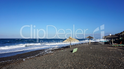 natural black lava beach koulombos on santorini island