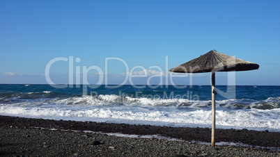 natural black lava beach koulombos on santorini island