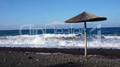 natural black lava beach koulombos on santorini island