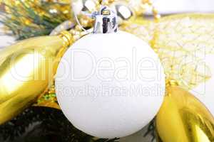 festive golden christmas decoration, candles, white balls, green fir tree branch, close up