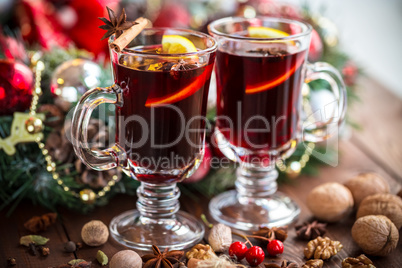 Christmas hot mulled wine with spices on a wooden table. The idea for creating greeting cards