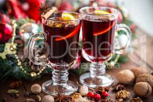 Christmas hot mulled wine with spices on a wooden table. The idea for creating greeting cards