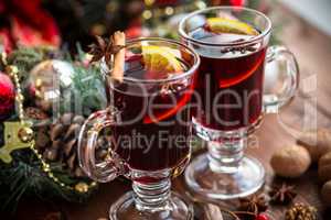 Christmas hot mulled wine with spices on a wooden table. The idea for creating greeting cards