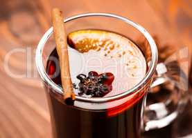 Christmas hot mulled wine with spices on a wooden table. The idea for creating greeting cards