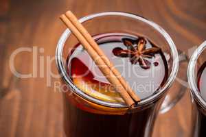 Christmas hot mulled wine with spices on a wooden table. The idea for creating greeting cards