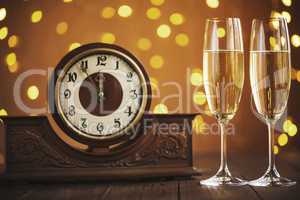 Christmas card. Glasses of champagne on New Year's Eve on the stand an ancient clock