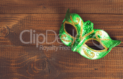 female carnival mask with wooden background