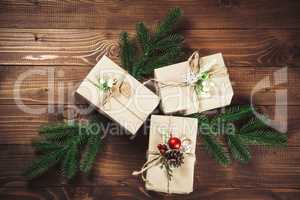 Christmas gift box with red ribbon on dark wooden background in vintage style