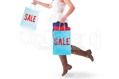 Composite image of happy brunette leaping with shopping bags