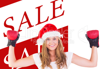 Composite image of festive blonde with boxing gloves