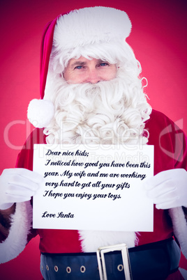 Composite image of cheerful santa claus holding page