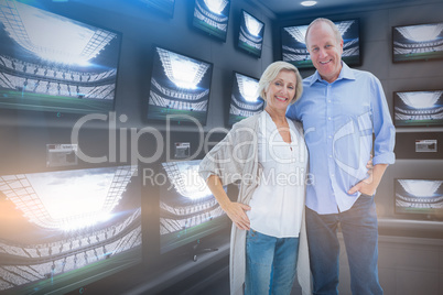 Composite image of happy mature couple hugging and smiling