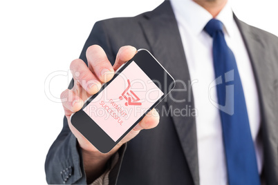 Composite image of businessman showing his smartphone screen