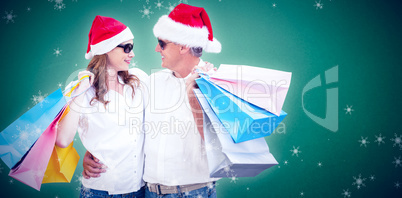 Composite image of christmas couple with shopping bags