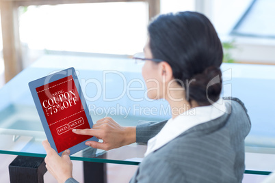 Composite image of businesswoman using digital tablet in office