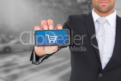 Composite image of businessman showing his smartphone screen