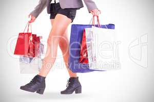 Lower half of woman with shopping bags